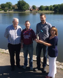 Cllr Mulgrew, Gerard Hughes, chair of the residents committee and council official Paddy Duffy with artist Alan Burke