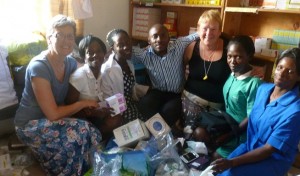 Christine Finlay (far left), Southern Health and Social Care Trust Dentist presenting medical supplies to staff at Rapha Medical Centre, Uganda including Paul Nsonga, Medical Officer (centre).