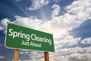 Spring Cleaning Just Ahead Green Road Sign and Clouds